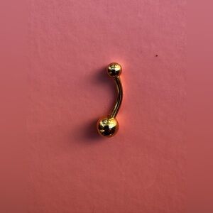 Gold tone belly button ring